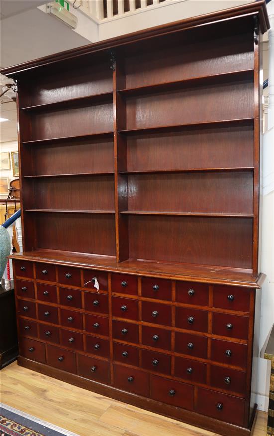 An Apothecaries dresser, fitted open shelves above a bank of forty small drawers W.174cm